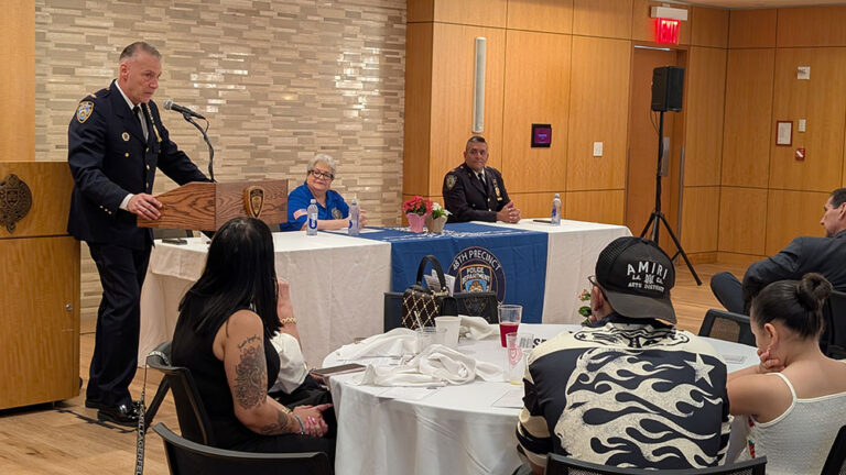 An officer speaks as guests look on