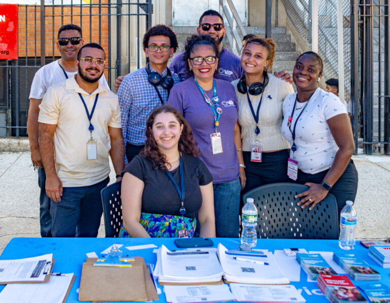 Staff pose at health fair outside VIP Community Services building in the Bronx