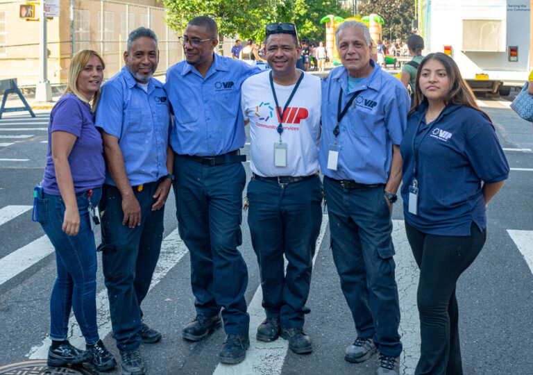 Staff pose at health fair outside VIP Community Services building in the Bronx