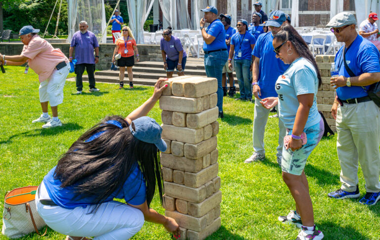 People play Jenga at community fair outside VIP Community Services building in the Bronx