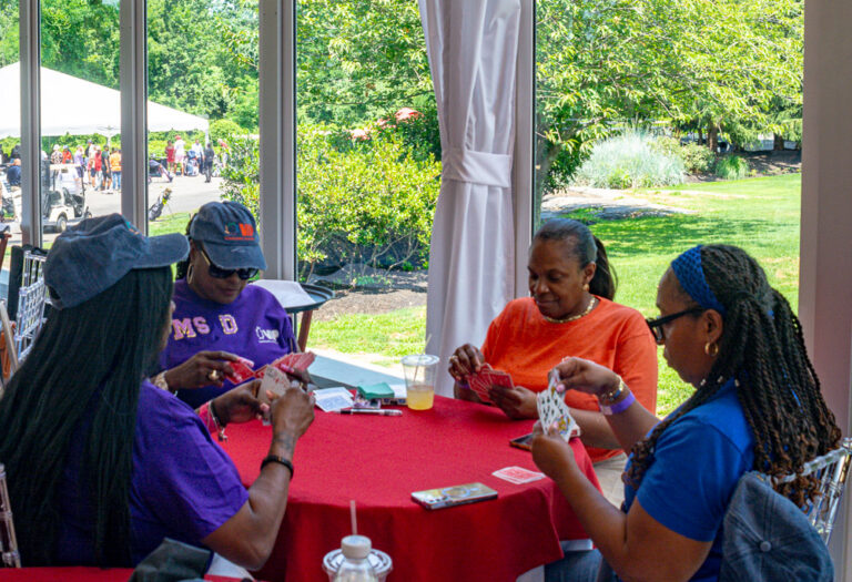 Staff play card games for Staff Appreciation Day at VIP Community Services