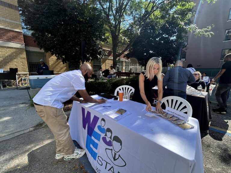 Attendee signs paper at table at VIP's 2026 Job Fair.
