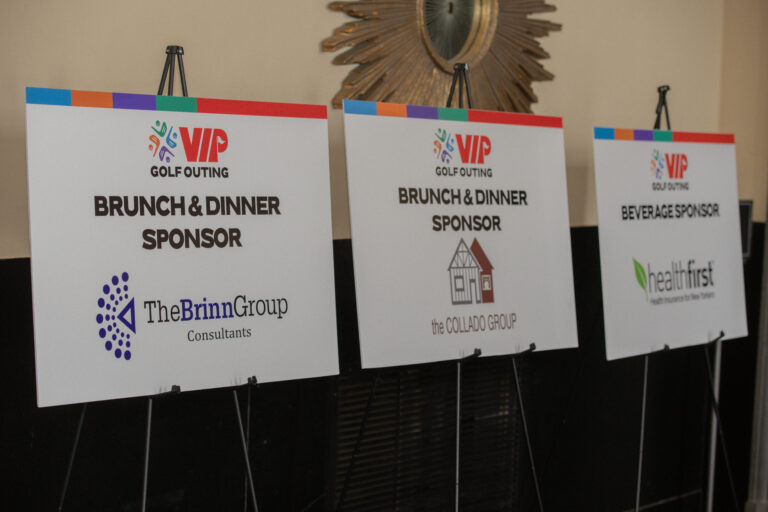 Signs lined up and displayed of the brunch and dinner sponsors, The Brinn Group LLC and The Collado Group, and beverage sponsor, Health First.