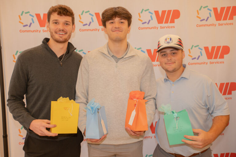 Winners of golf competition pose for photo.