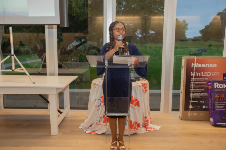 President and CEO Debbian Fletcher-Blake speaks at podium during the dinner reception at VIP's Inaugural Golf Outing.