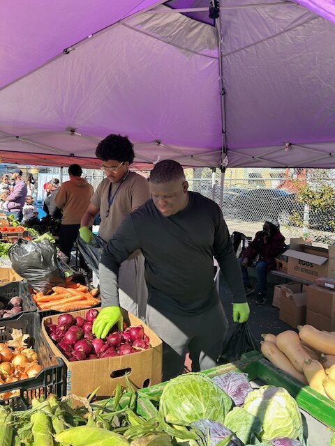 Volunteers handing out fresh produce at the Fruit & Vegetable Distribution.